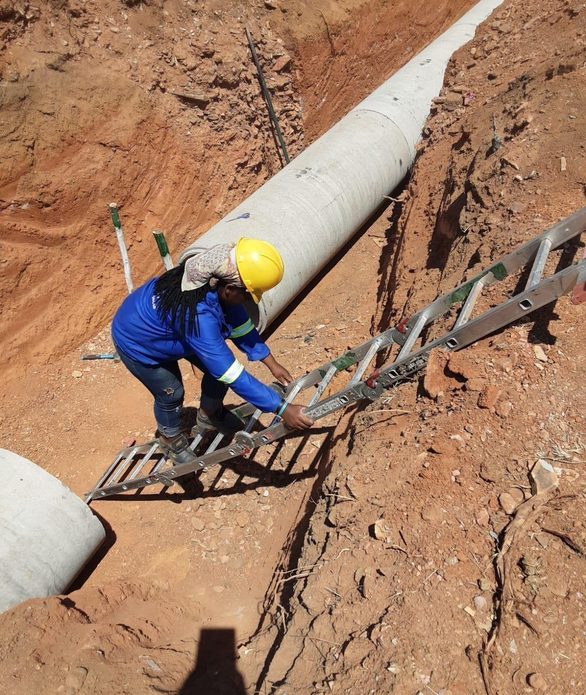 Pat and Lin team member installing a concrete pipe